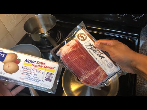 Making breakfast for dinner! Bacon, eggs and grits with cheese.